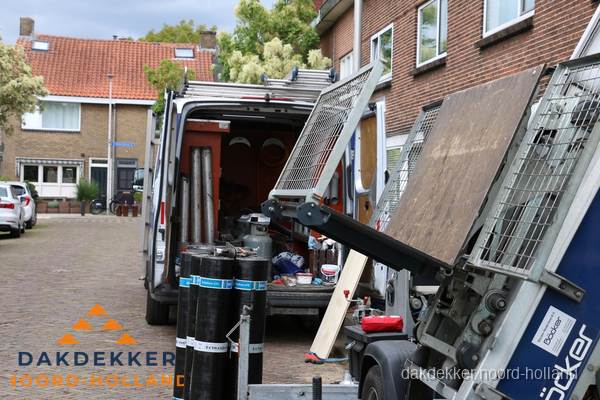 Dakdekkersbusje met materiaal en ladderlift voor dakpannen vervangen in Noord-Holland
